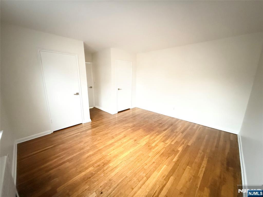 293 Bogert Road, Unit 1A River Edge, NJ 07661 - Photo 13 of 14 a view of empty room with wooden floor