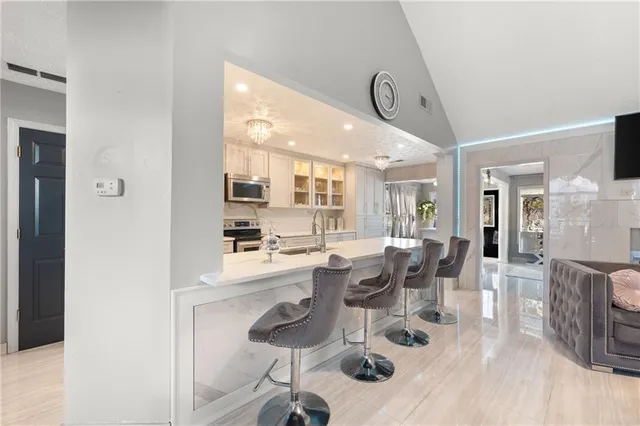 a view of a kitchen with cabinets and wooden floor