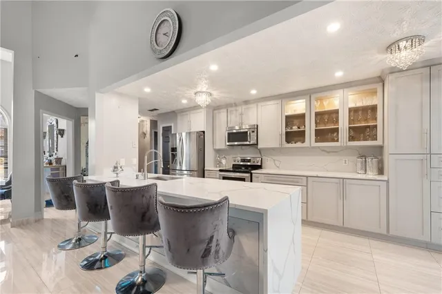 a kitchen with sink stove and living room