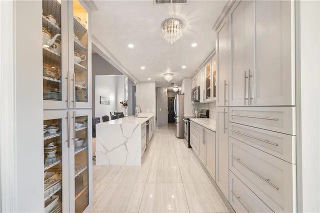 a view of a kitchen with a sink and dishwasher a refrigerator with wooden floor