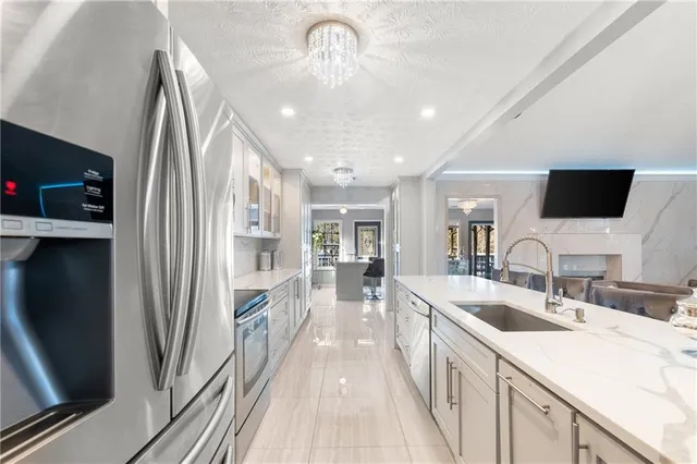 a bedroom with a large bed and a flat tv screen