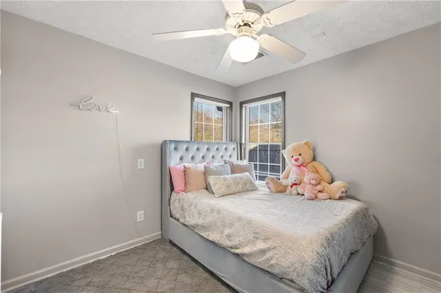 a bedroom with a large bed and a chandelier