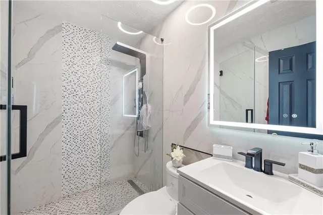 a roof deck with table and chairs and potted plants