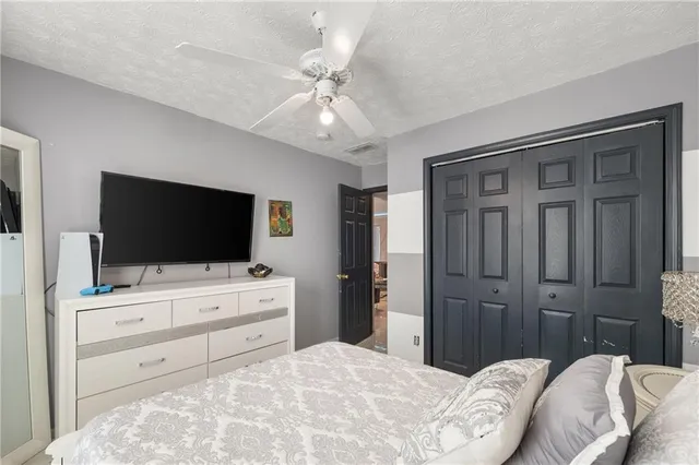 a view of a house with a yard porch and wooden fence
