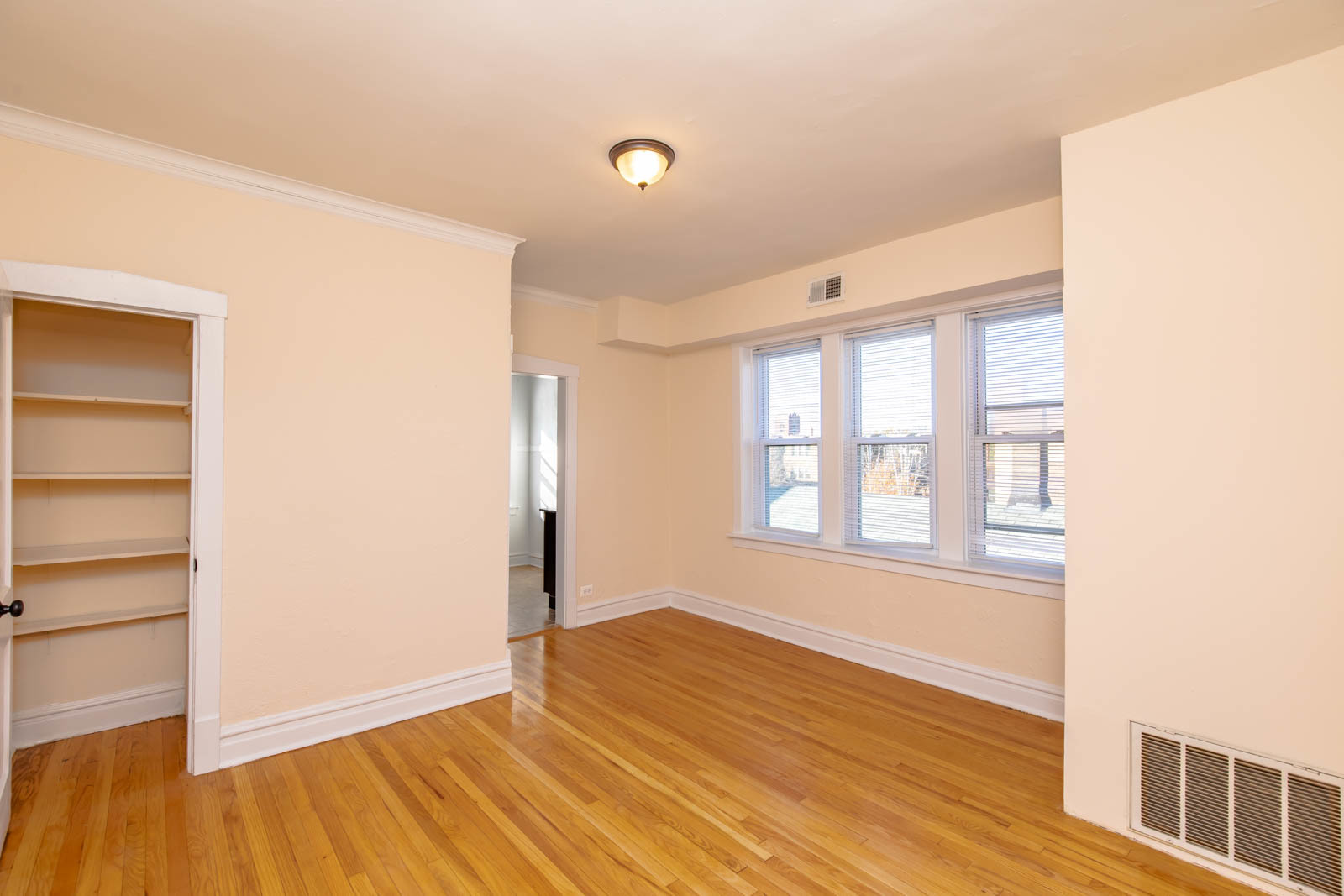 4823 North Springfield Avenue, Unit 3W Chicago, IL 60625 - Photo 2 of 13 a view of an empty room with wooden floor and a window