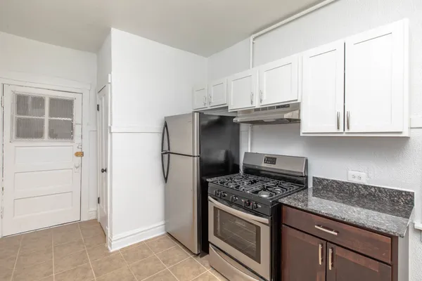 a kitchen with granite countertop cabinets and steel stainless steel appliances