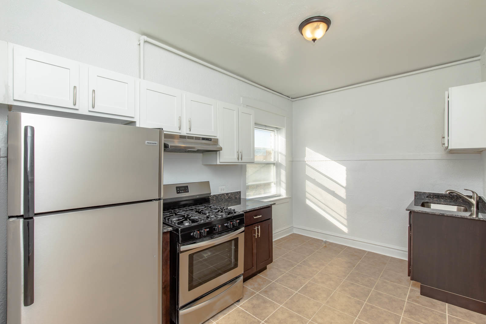4823 North Springfield Avenue, Unit 3W Chicago, IL 60625 - Photo 6 of 13 a kitchen with stainless steel appliances granite countertop a refrigerator sink and stove
