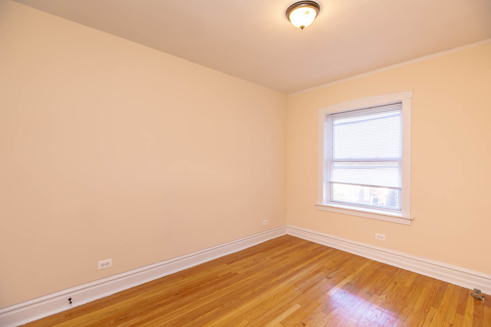 4823 North Springfield Avenue, Unit 3W Chicago, IL 60625 - Photo 8 of 13 an empty room with wooden floor and windows