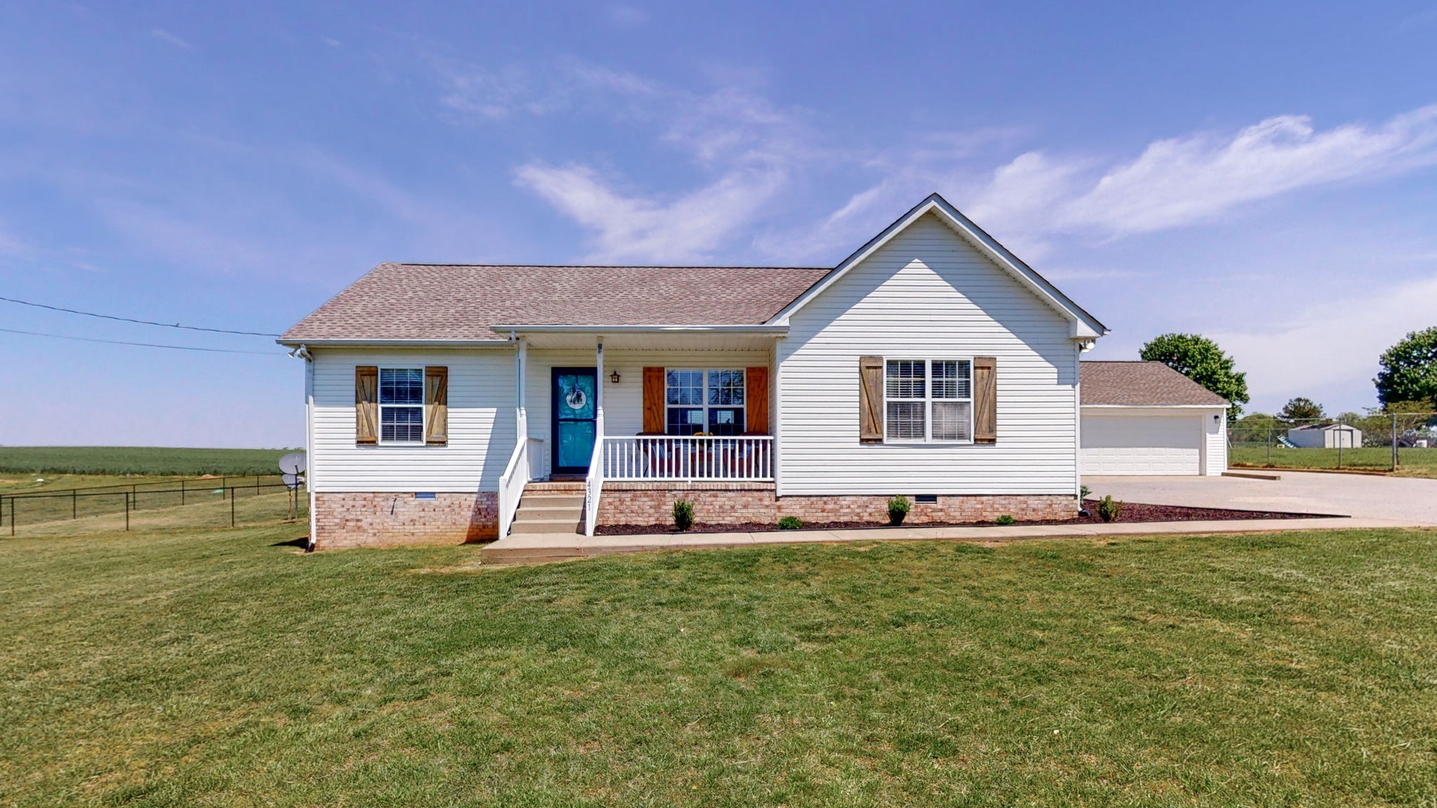 4321 Matthews Road Cedar Hill, TN 37032 - Photo 1 of 29 a front view of a house with a yard and garage
