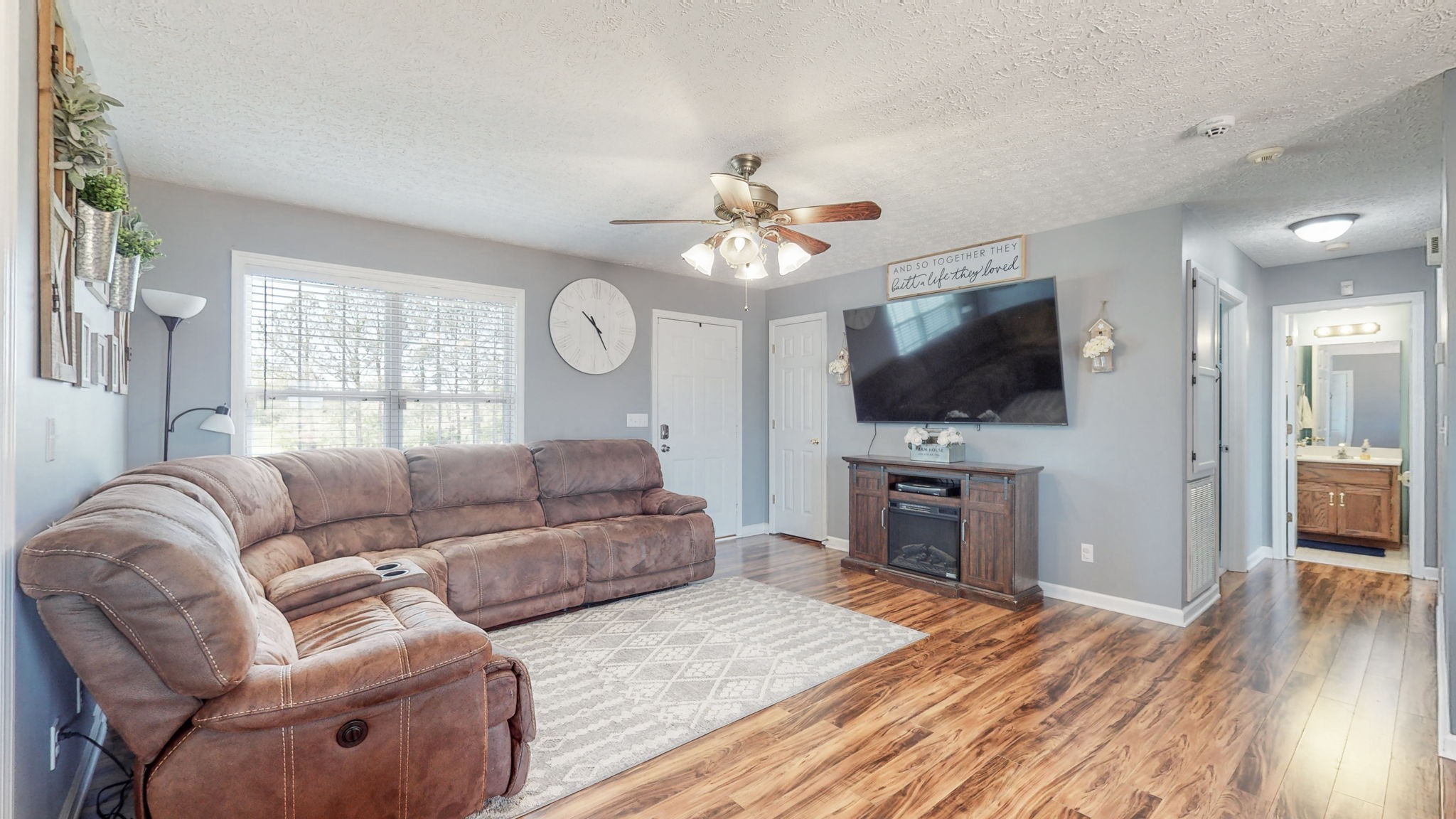 4321 Matthews Road Cedar Hill, TN 37032 - Photo 11 of 29 a living room with furniture a flat screen tv and a fireplace