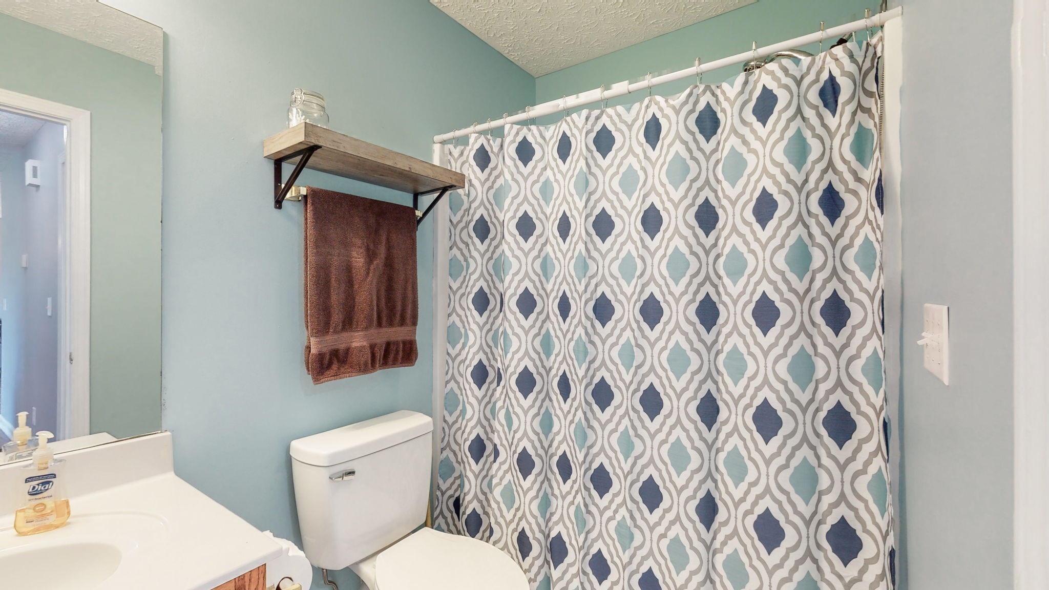 4321 Matthews Road Cedar Hill, TN 37032 - Photo 26 of 29 a white toilet sitting next to a white sink and a shower curtain