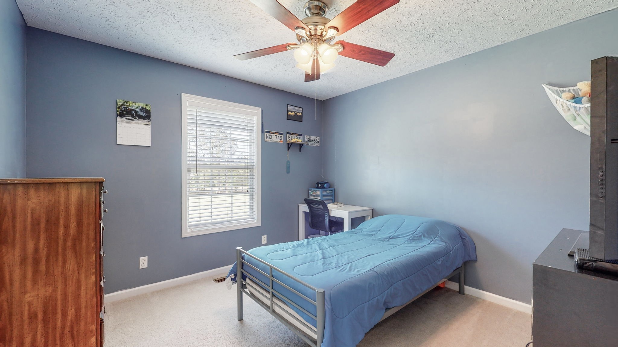 4321 Matthews Road Cedar Hill, TN 37032 - Photo 27 of 29 a bedroom with a bed and a chandelier