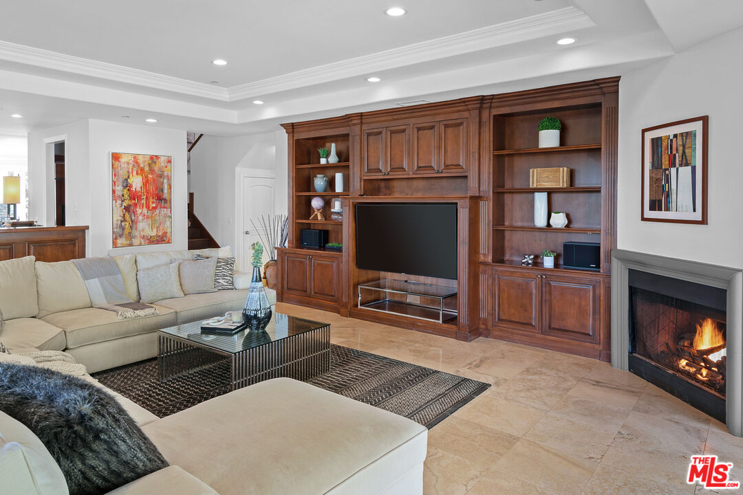 23575 Parksouth Street Calabasas, CA 91302 - Photo 17 of 75 a living room with furniture a flat screen tv and a fireplace