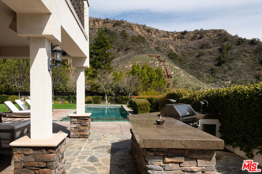 23575 Parksouth Street Calabasas, CA 91302 - Photo 22 of 75 a view of a patio with couches table and chairs and potted plants