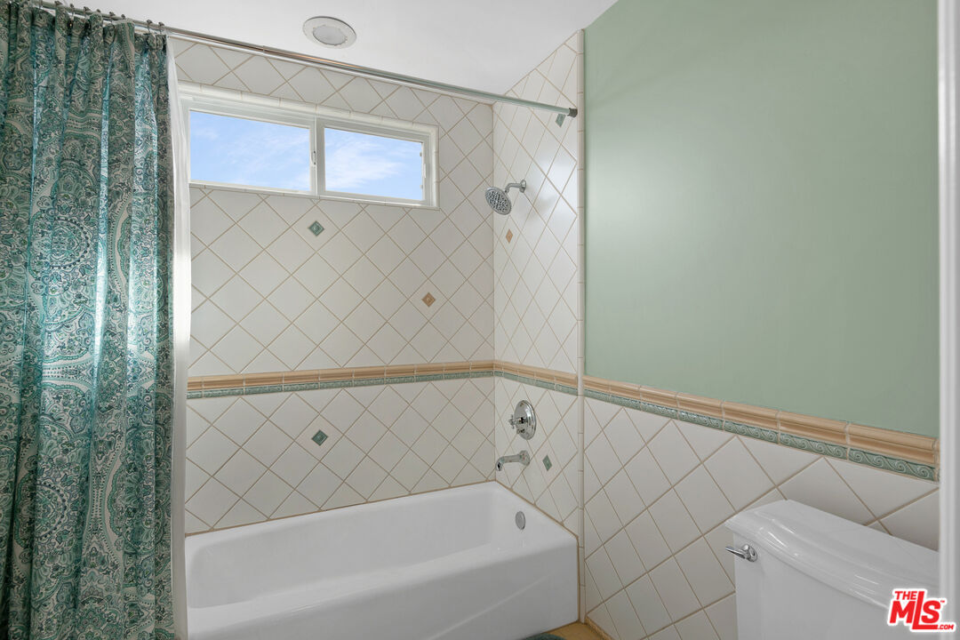 23575 Parksouth Street Calabasas, CA 91302 - Photo 58 of 75 a bathroom with a bathtub and a shower