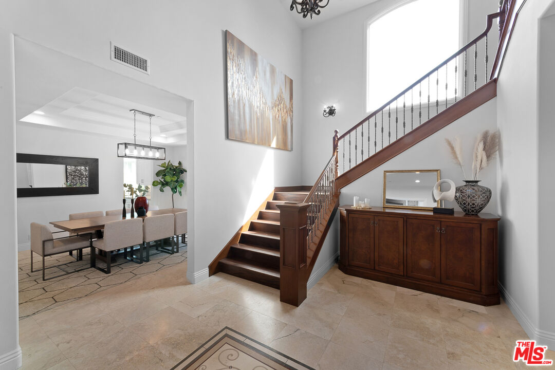 23575 Parksouth Street Calabasas, CA 91302 - Photo 6 of 75 a living room with furniture and stairs