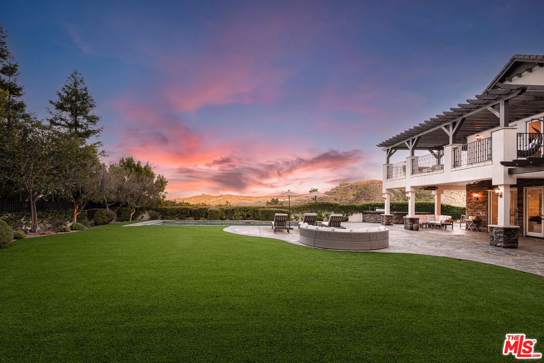 23575 Parksouth Street Calabasas, CA 91302 - Photo 66 of 75 a view of a garden with a house in the background