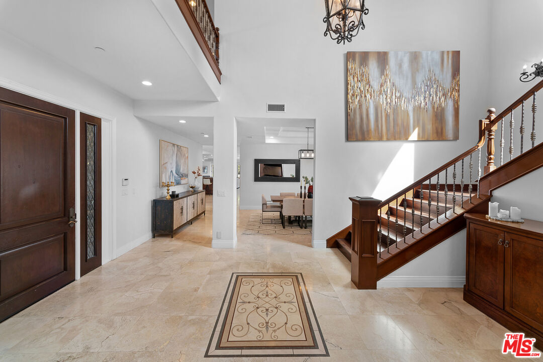 23575 Parksouth Street Calabasas, CA 91302 - Photo 7 of 75 a living room with furniture stairs and a wooden floor