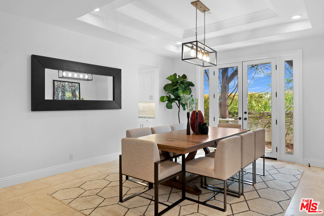 23575 Parksouth Street Calabasas, CA 91302 - Photo 8 of 75 a dining room with furniture potted plants and wooden floor