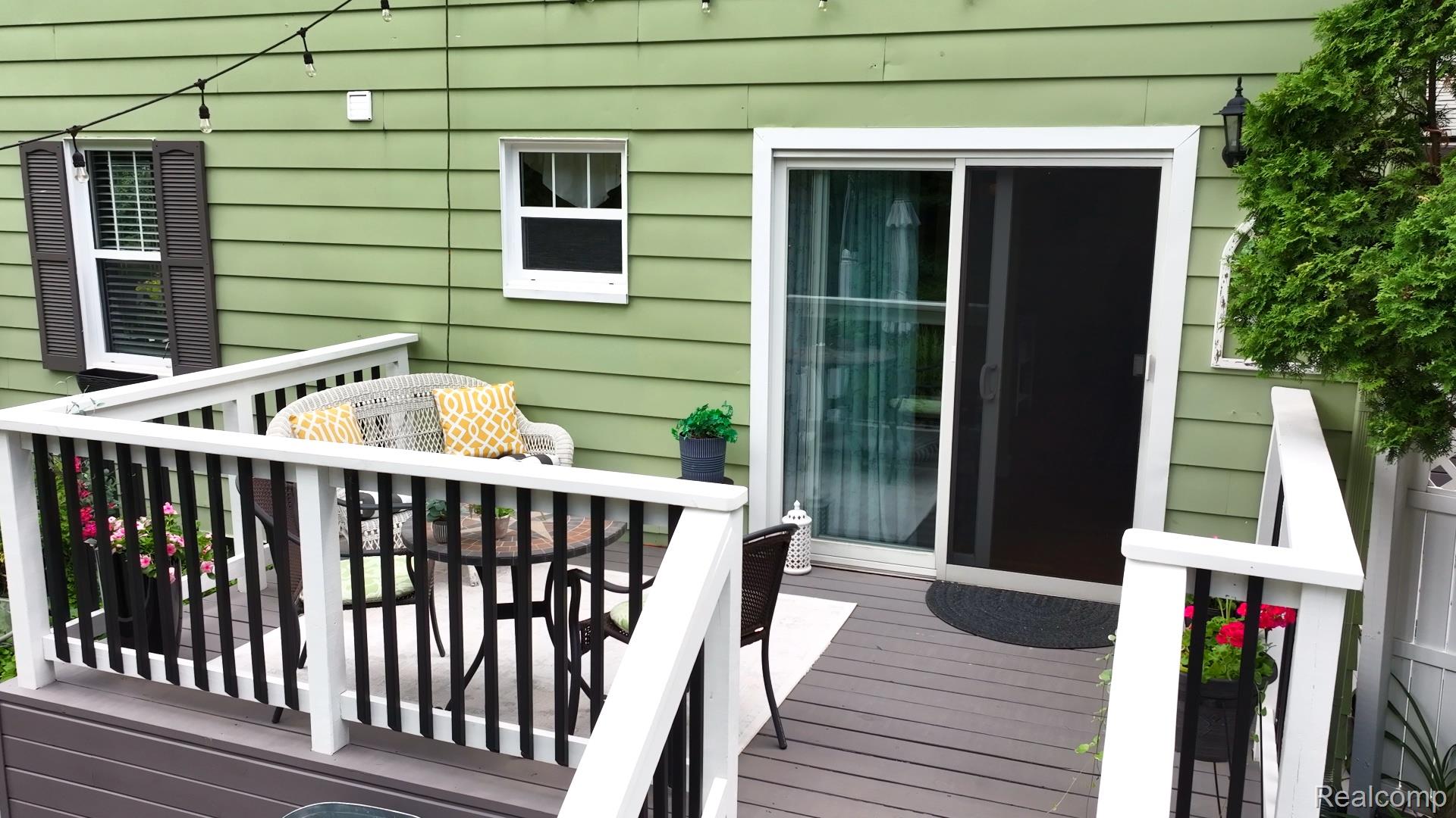 3841 Covert Road Waterford, MI 48328 - Photo 78 of 87 Deck featuring composite decking, white railings with black balusters, and a sliding glass door