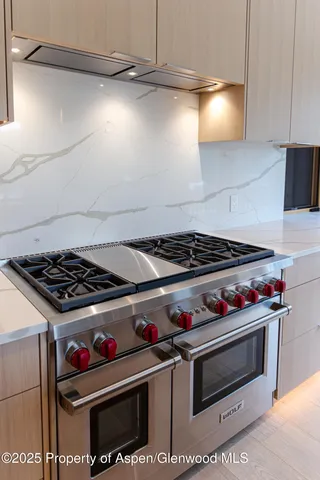 a view of a brick house with large windows