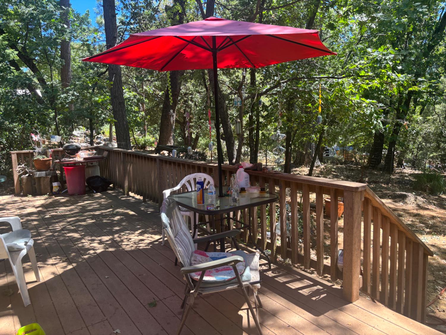 15574 Hinton Road Pioneer, CA 95666 - Photo 26 of 44 a view of a balcony with wooden floor and umbrella