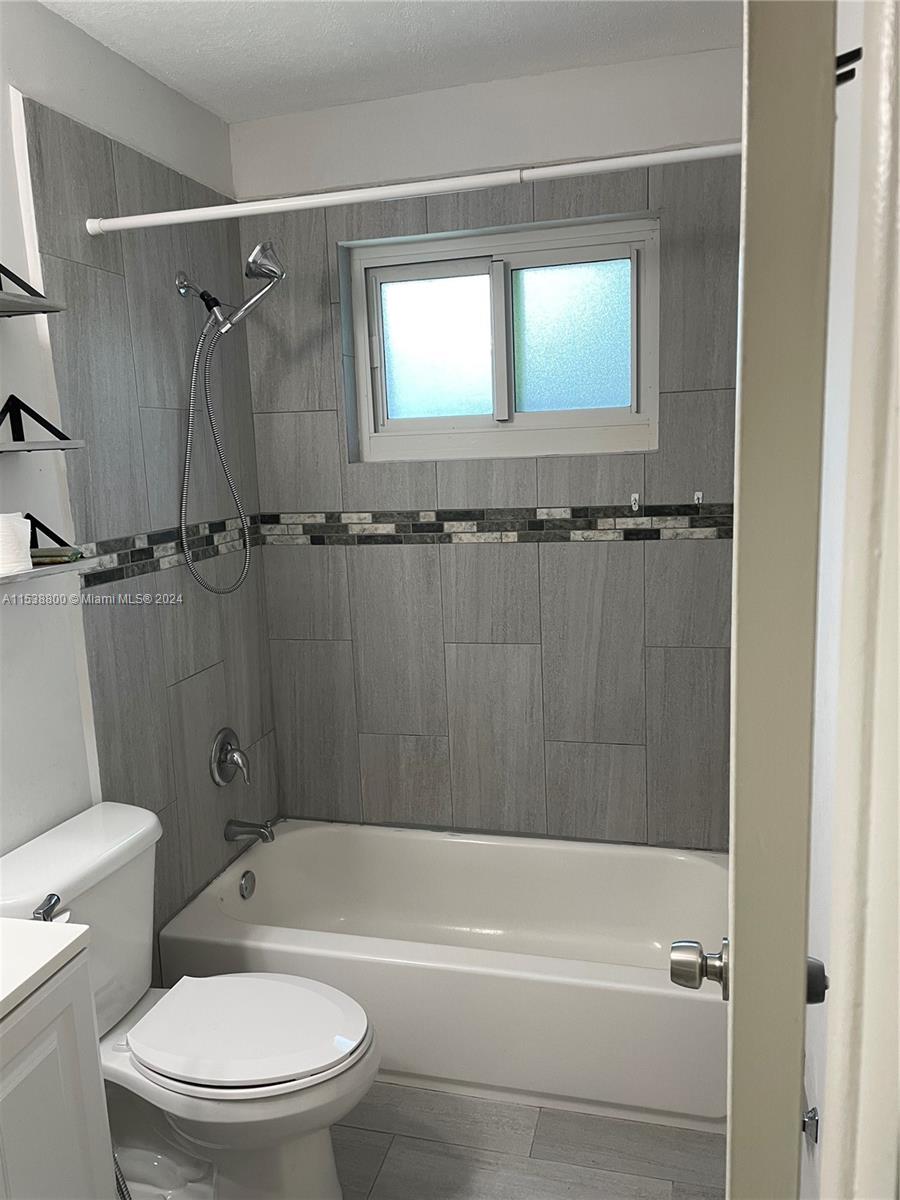 a bathroom with a bathtub toilet and shower