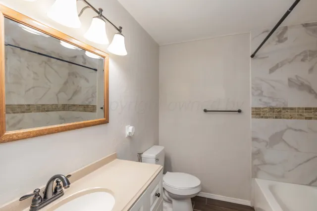 a white toilet sitting next to a bath tub shower