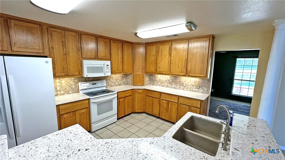 729 Armadillo Lane Kempner, TX 76539 - Photo 4 of 45 a kitchen with a refrigerator sink and cabinets