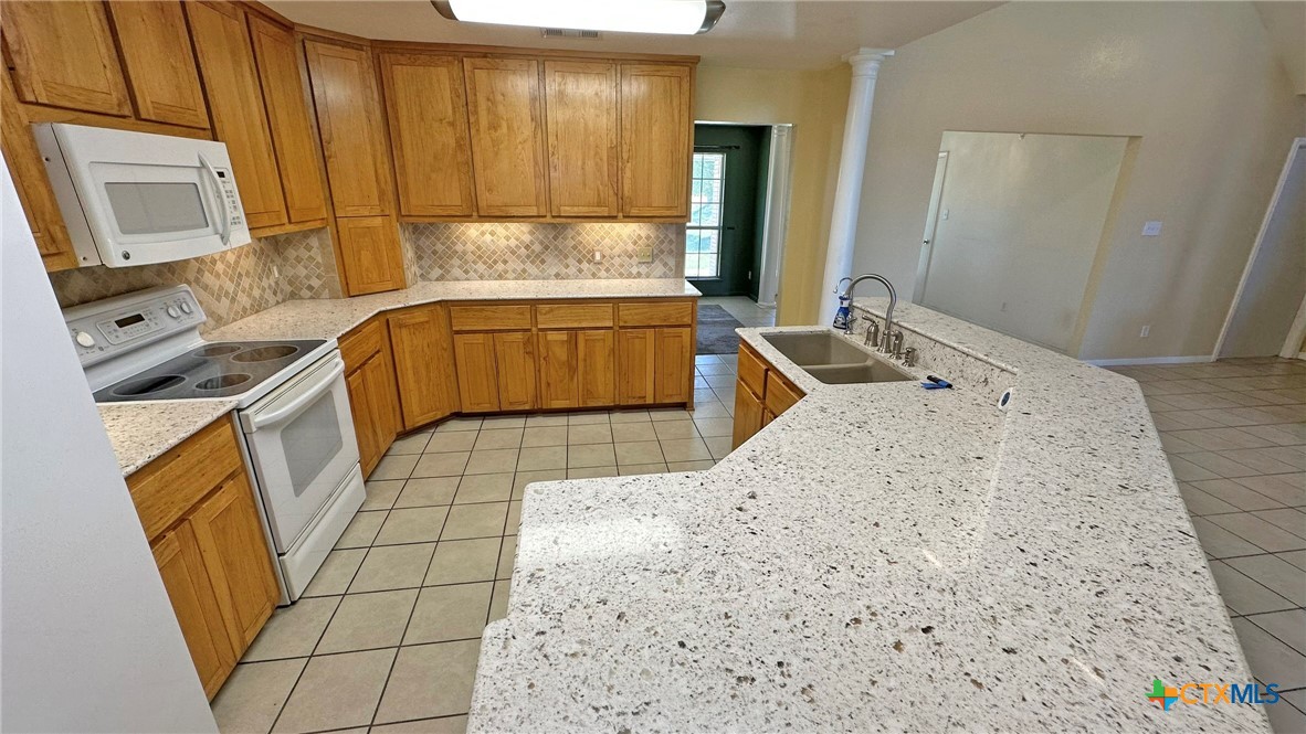 729 Armadillo Lane Kempner, TX 76539 - Photo 5 of 45 a kitchen with a sink stove and refrigerator