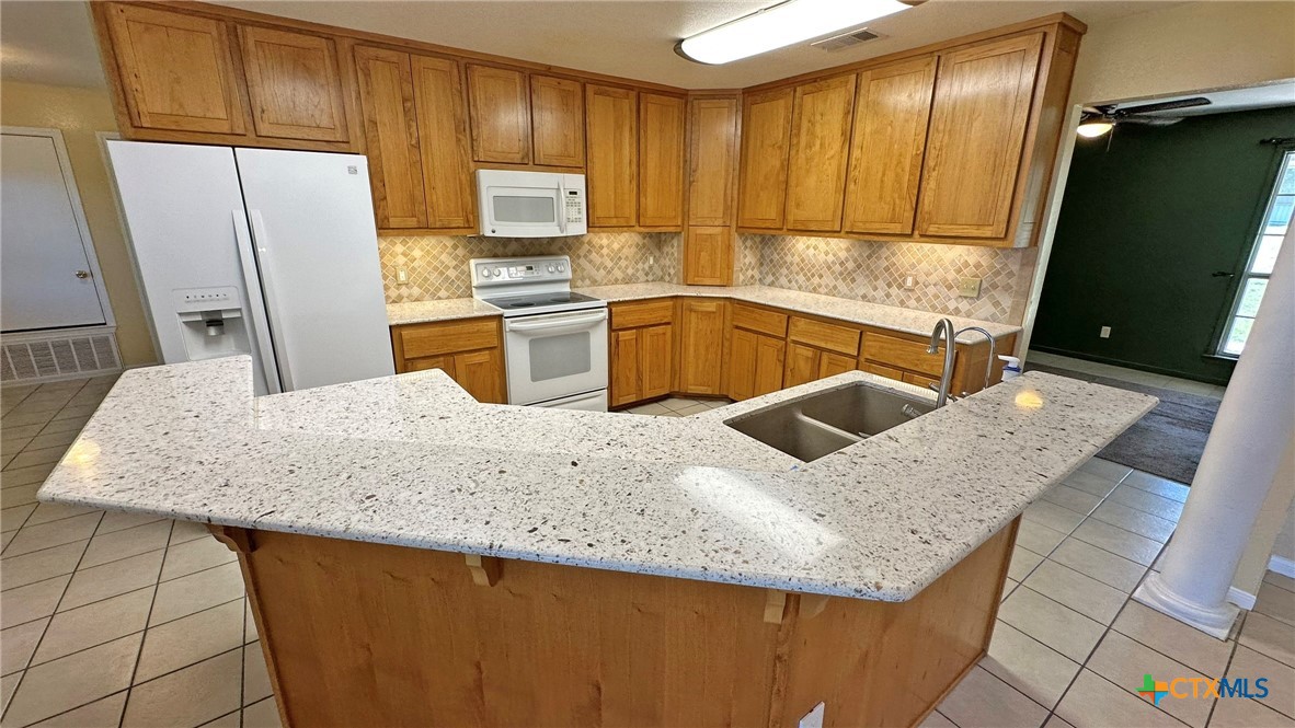 729 Armadillo Lane Kempner, TX 76539 - Photo 6 of 45 a kitchen with stainless steel appliances granite countertop a sink a refrigerator and a stove