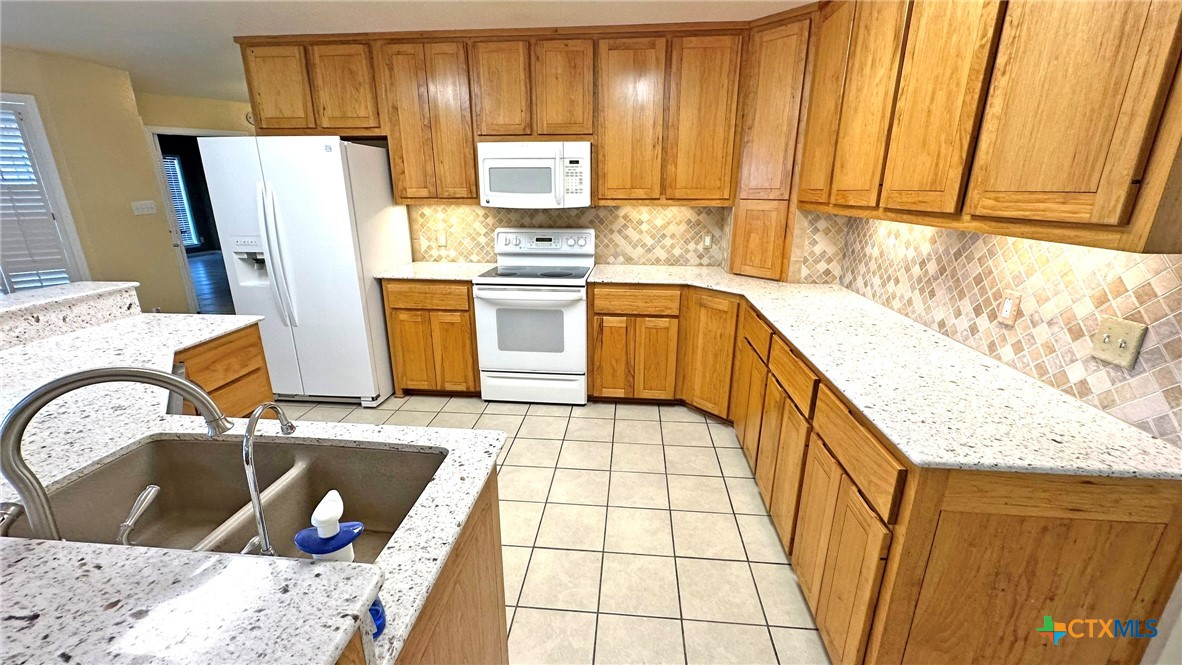 729 Armadillo Lane Kempner, TX 76539 - Photo 7 of 45 a kitchen with sink refrigerator and microwave