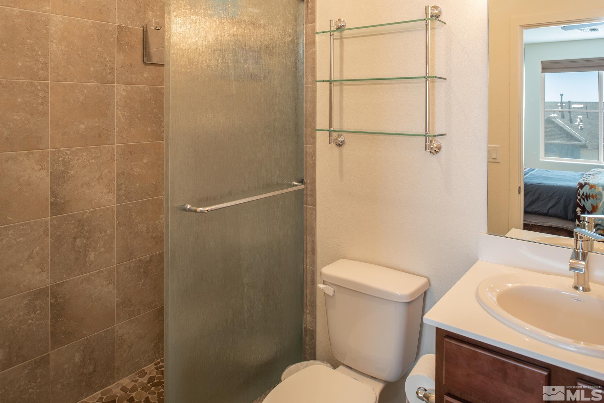 575 Logan Jacob Lane Reno, NV 89503 - Photo 17 of 31 a white toilet sitting next to a bathroom sink