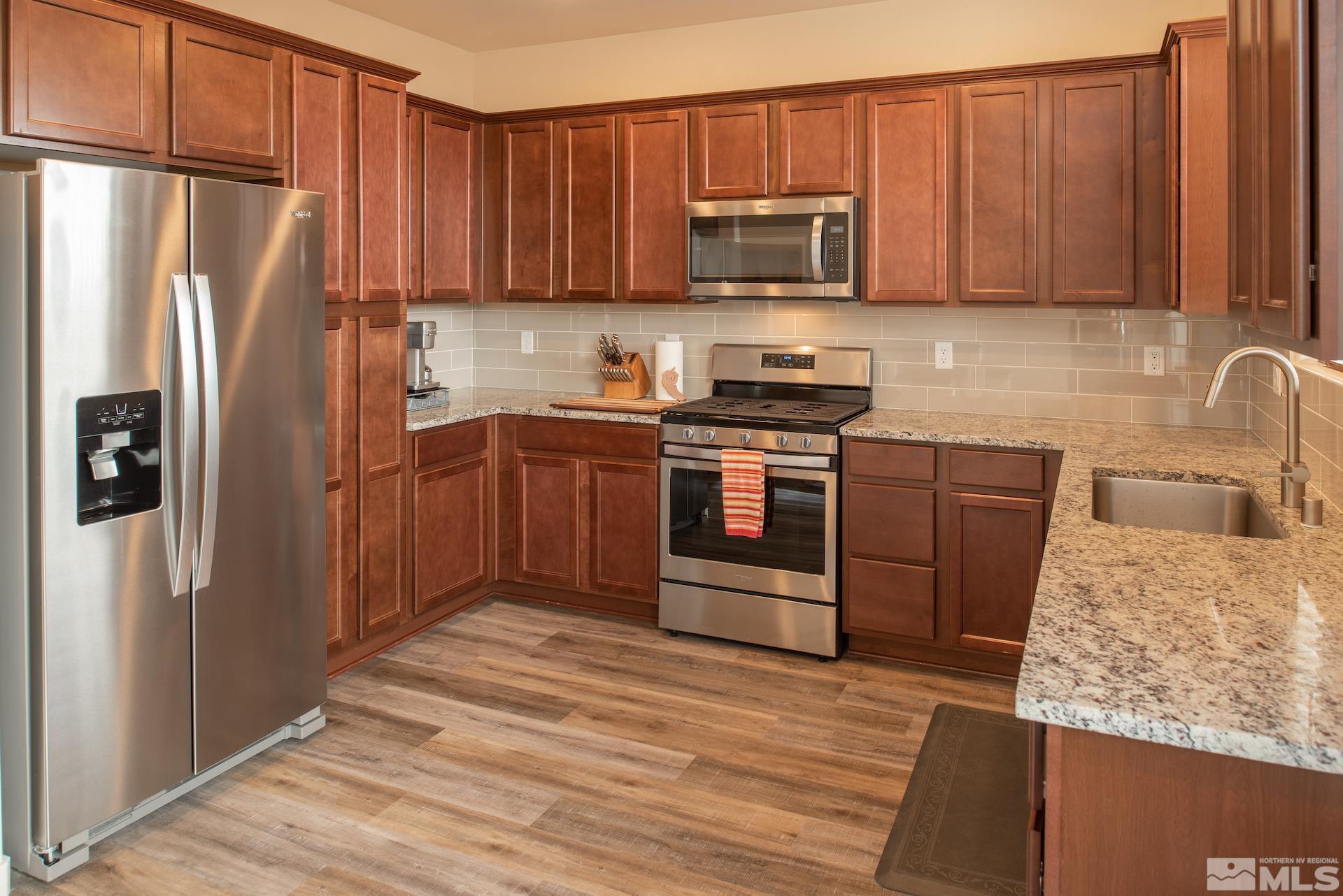 575 Logan Jacob Lane Reno, NV 89503 - Photo 10 of 31 a kitchen with stainless steel appliances granite countertop a refrigerator stove and sink