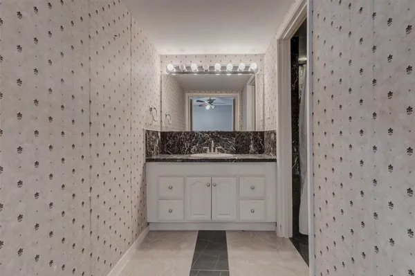 a bathroom with a sink a vanity and a mirror