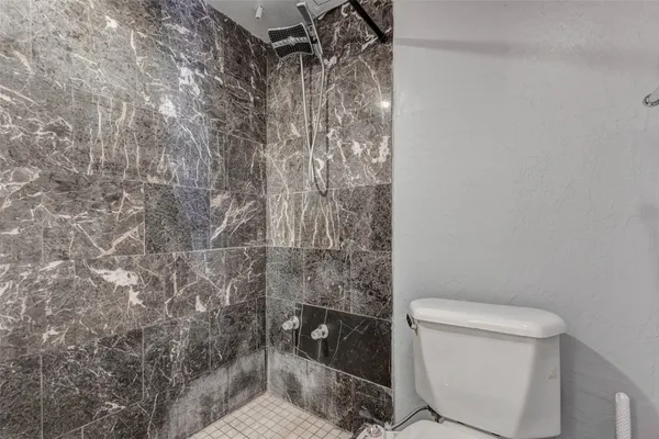 a bathroom with a toilet and shower