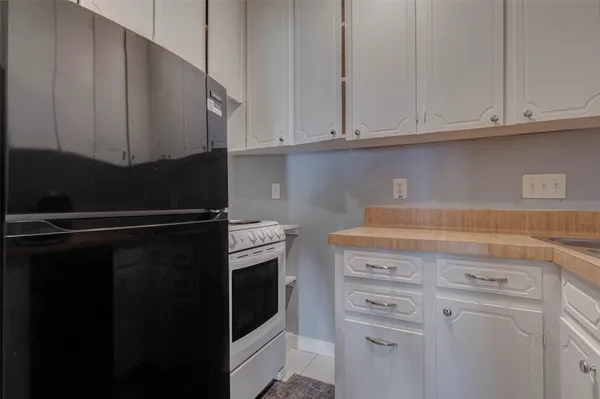 a kitchen with stainless steel appliances white cabinets and a sink