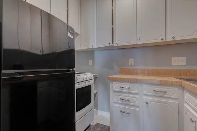 a kitchen with stainless steel appliances white cabinets and a sink