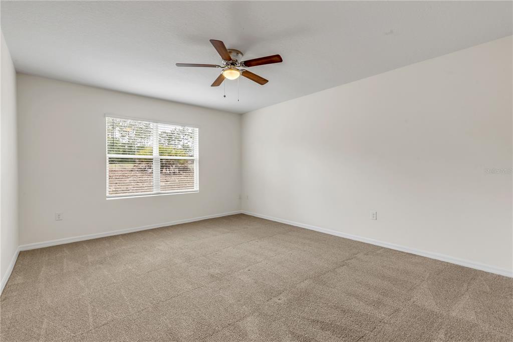 48 Hickory Loop Ocala, FL 34472 - Photo 24 of 52 an empty room with windows and fan