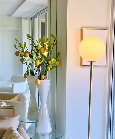 a vase of flowers with a table and chairs