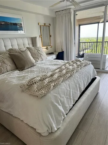 a large bed sitting in a bedroom next to a window