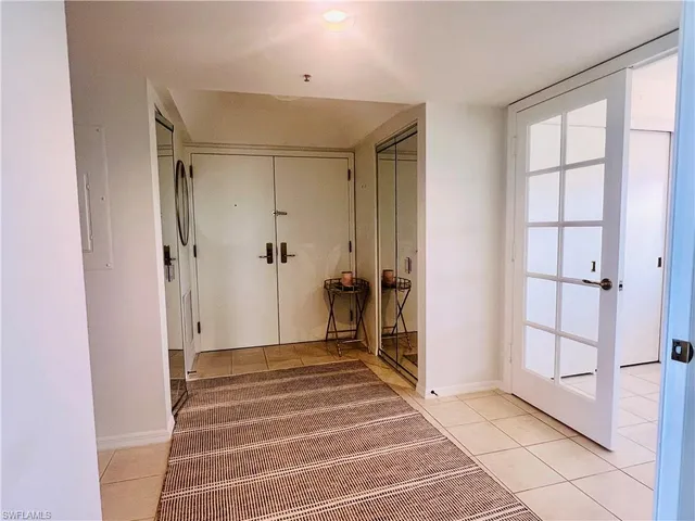 a view of a hallway with wooden floor and entryway