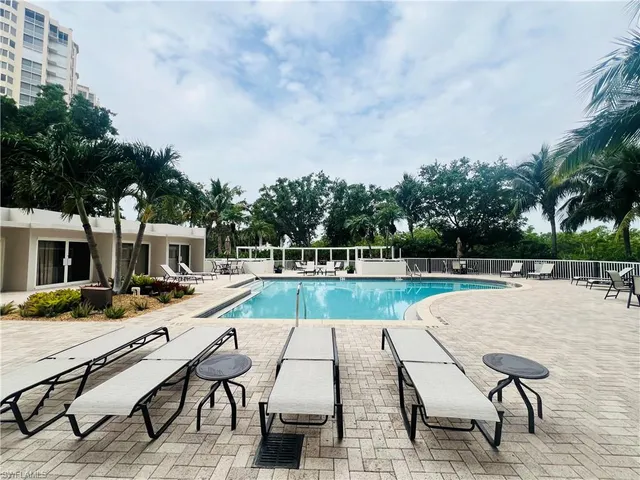 a swimming pool with outdoor seating and yard
