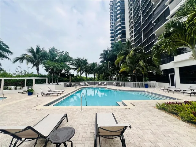 a view of a swimming pool with lounge chairs