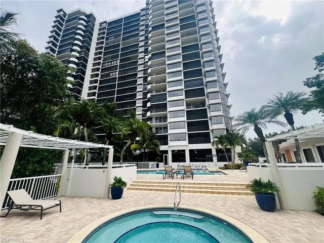 a view of roof deck with chairs and wooden fence
