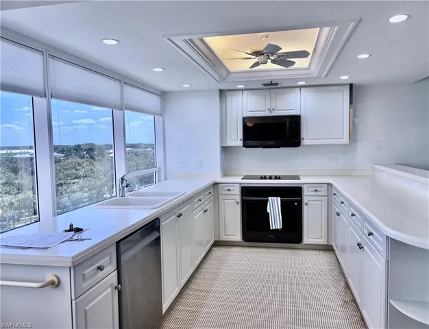 a kitchen with a sink stove and microwave