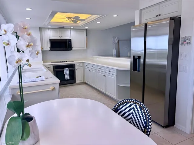 a kitchen with a sink stainless steel appliances and a counter top space