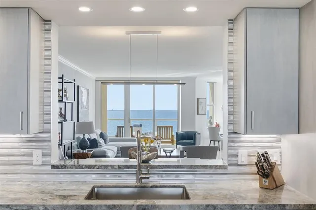 a living room with fireplace furniture and a chandelier