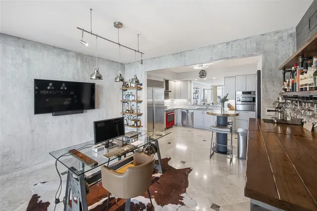 a view of a swimming pool with lawn chairs and plants