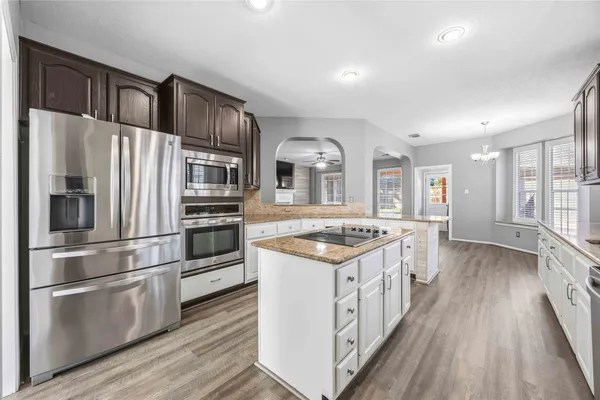 a kitchen with stainless steel appliances granite countertop a stove and a refrigerator